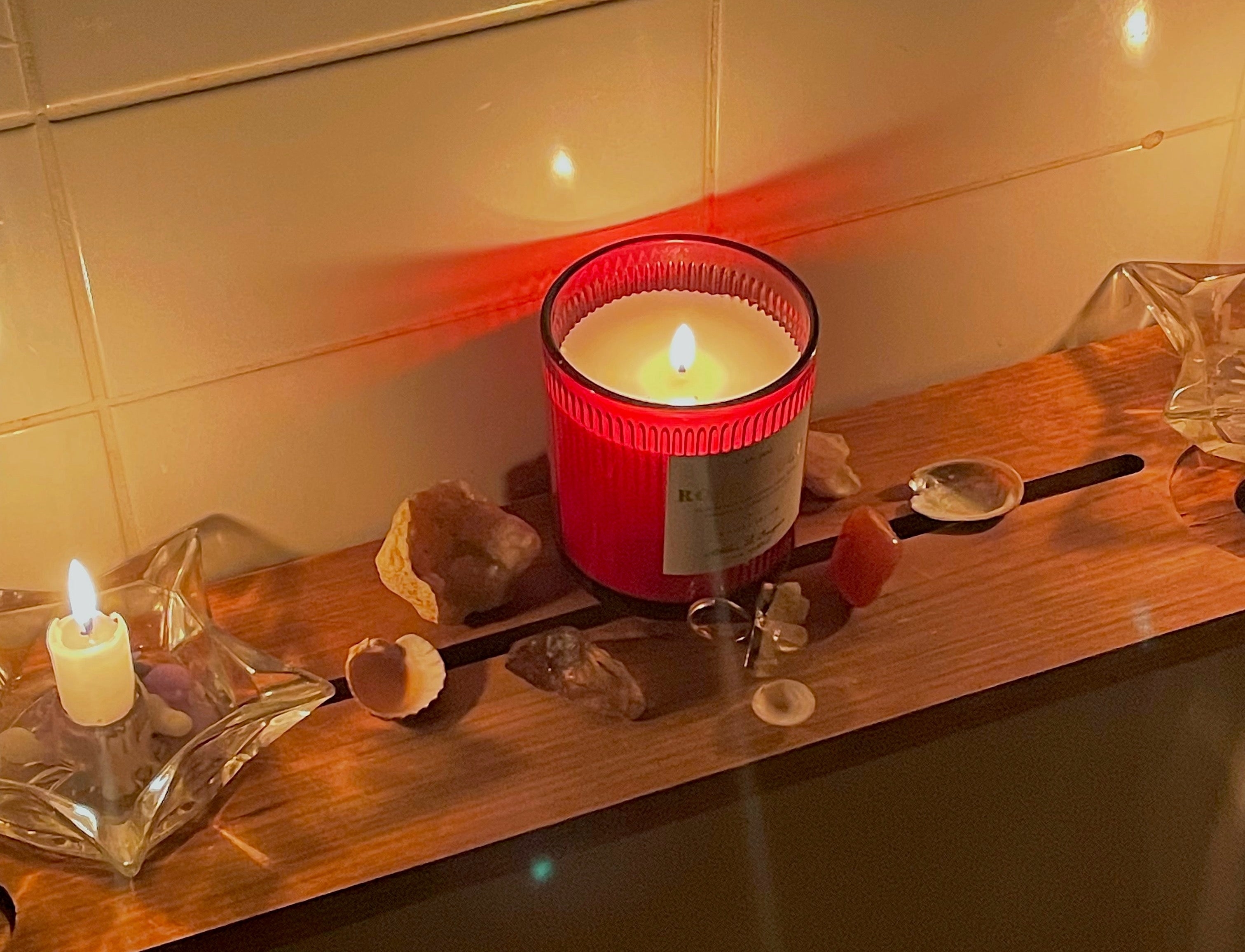 libra aesthetic photo featuring candles and crystals in dimly lit room