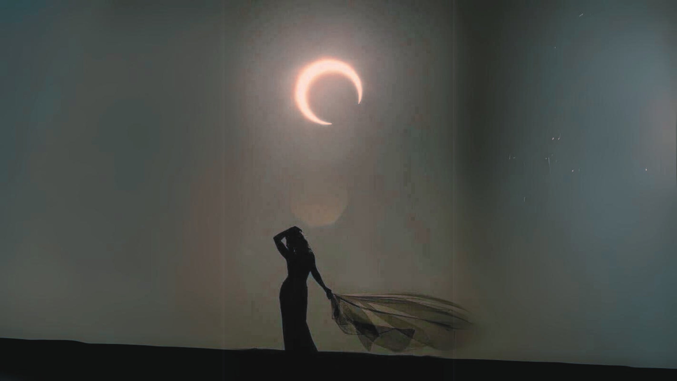 silhouette of woman beneath full moon lunar eclipse